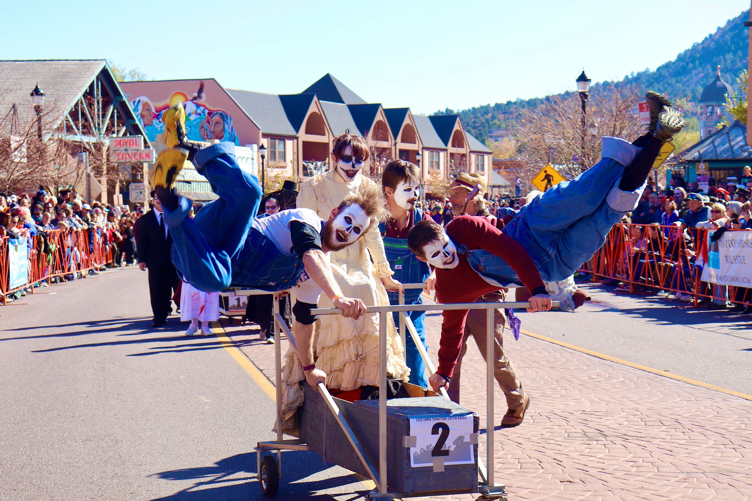 a group of people in costume pose with their racing coffin
